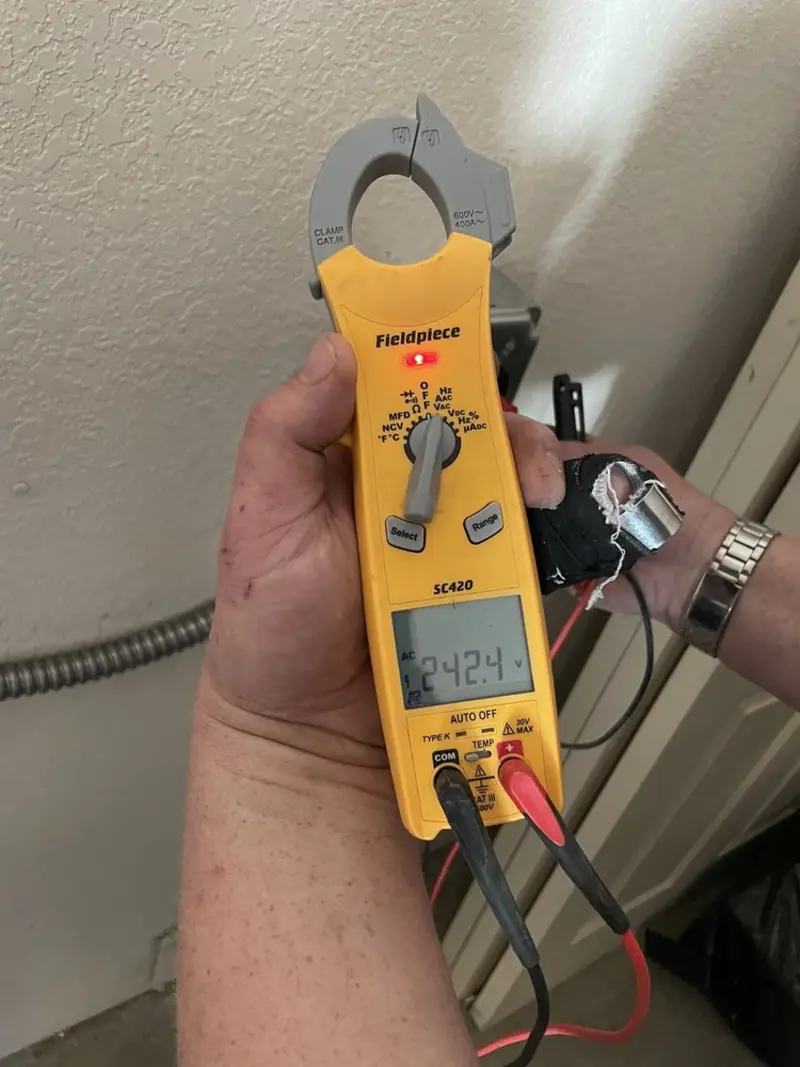 Voltage testing with clamp meter during Electrical Installation Services in St. Andrews